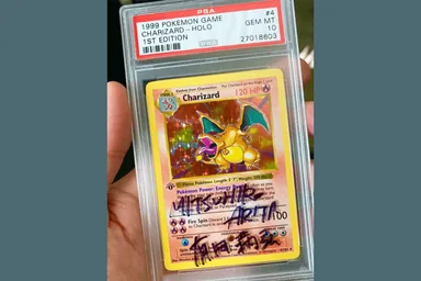 Pokémon Base Set first-edition Charizard — PSA 10, signed by Mitsuhiro Arita — source photo